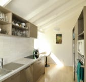 Master bedroom with light blue wallpaper and linen curtains 